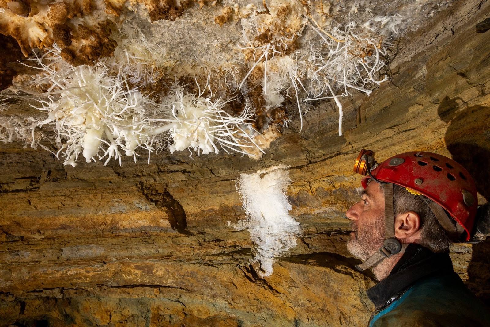 Club member looking into a cave entrance
