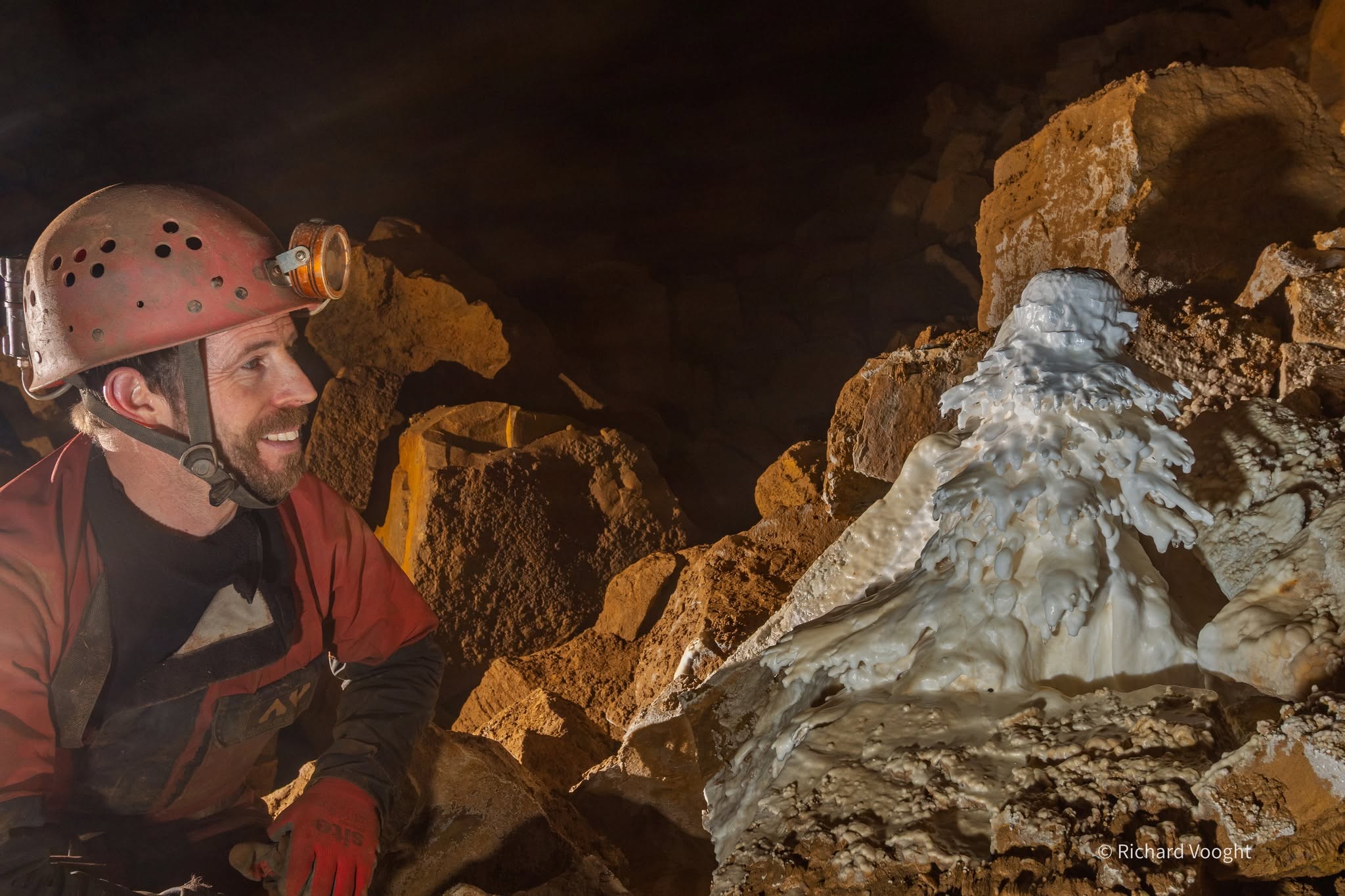 Member looking into a cave